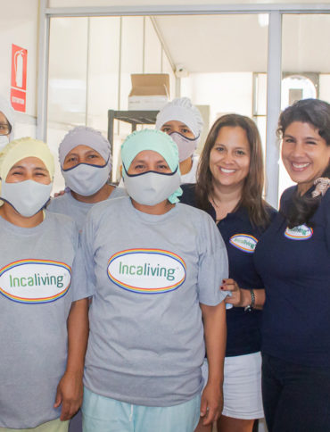 Incaliving Team at the Plant wearing "Incaliving" logo grey shirts, hair nets, and masks.
