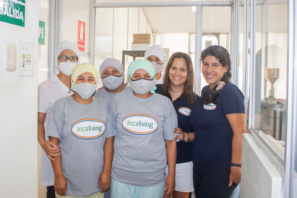 Incaliving Team at the Plant wearing "Incaliving" logo grey shirts, hair nets, and masks.