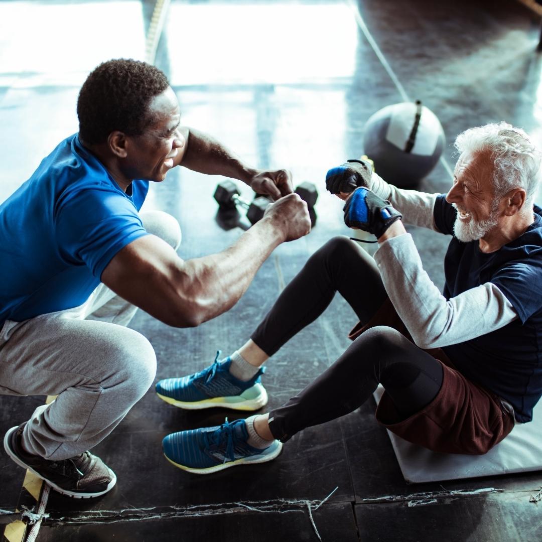 Black man and older white man working out together.
